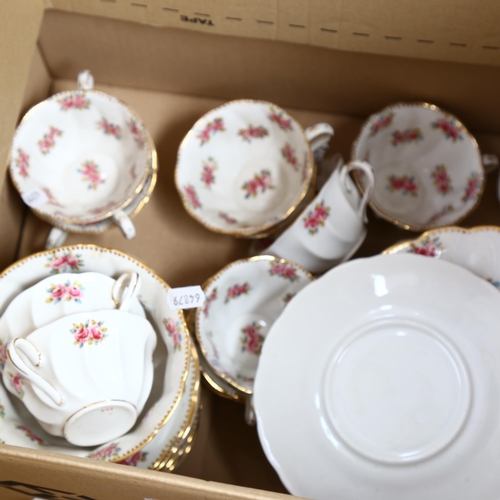 551 - A ceramic tea set for 10 people, white ground decorated with flowers (pattern 227?)