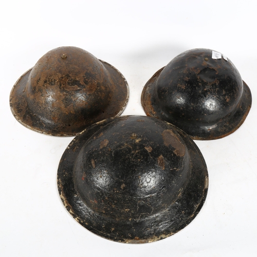 573 - 3 World War II Brodie helmets, all with original linings