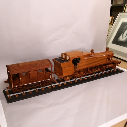 610 - A large scratch-built wooden steam engine and carriage, and 2 sections of track, steam engine length... 