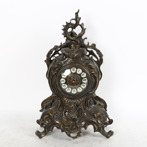 639 - An Antique style cast-metal clock, with scrolled surround and quartz movement, height 38cm