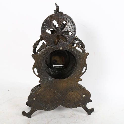 639 - An Antique style cast-metal clock, with scrolled surround and quartz movement, height 38cm