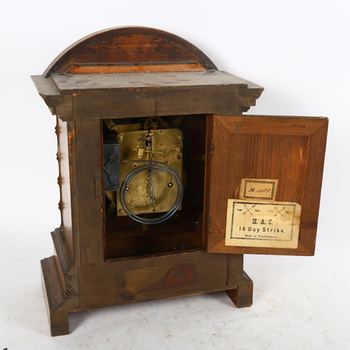 640 - An early 20th century carved walnut-cased 8-day mantel clock with enamel dial, height 36cm