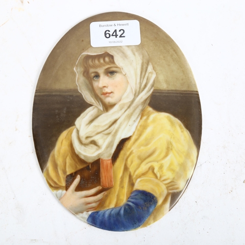 642 - A Continental painted ceramic oval plaques, depicting a young girl holding a book, length 16.5cm