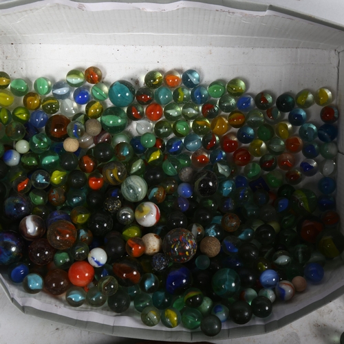 657 - A Solitaire board, and a large quantity of various marbles