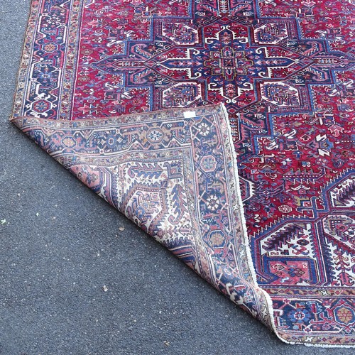 2381 - A red and blue ground Caucasian carpet, 385cm x 282cm