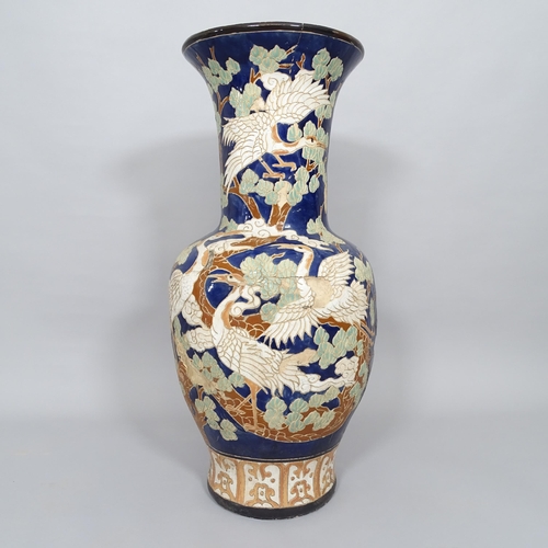 2503 - A large Chinese  blue glazed terracotta garden urn, with bird and tree decoration, H80cm