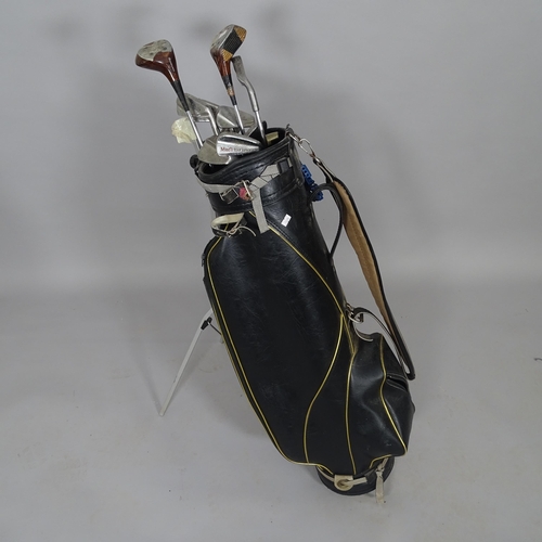 2512 - A golf bag and 11 Vintage golf clubs