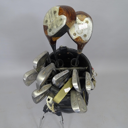 2512 - A golf bag and 11 Vintage golf clubs