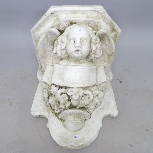 2696 - A composition garden wall bracket, with cherub decoration, 35cm x 40cm