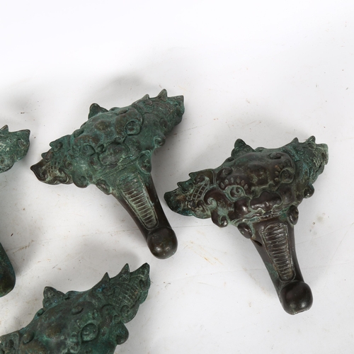 813 - A set of 4 Chinese solid cast verdigris bronze feet, height 12cm