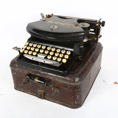 867 - An early 20th century The Empire portable typewriter, in tin case