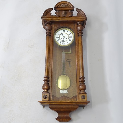 2520 - An Antique oak-cased wall clock, with key and pendulum, 45cm x 115cm x 20cm