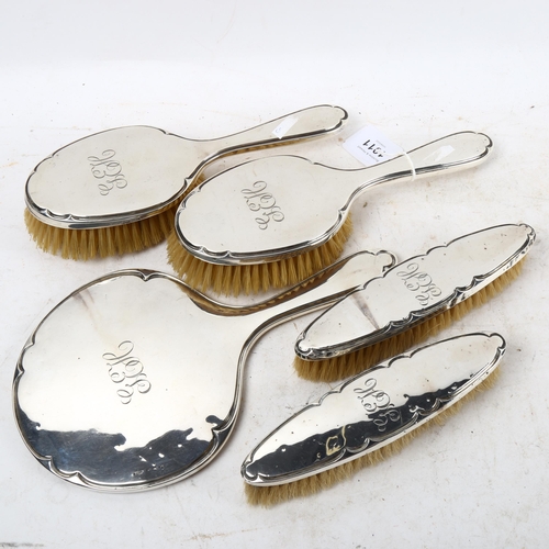 1011 - A suite of George V silver-backed dressing table brushes and mirror, hallmarks for Birmingham 1914 a... 