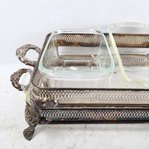 1022 - A graduated pair of 2-handled entree dishes with glass liners, on cast feet, and a silver plated sca... 