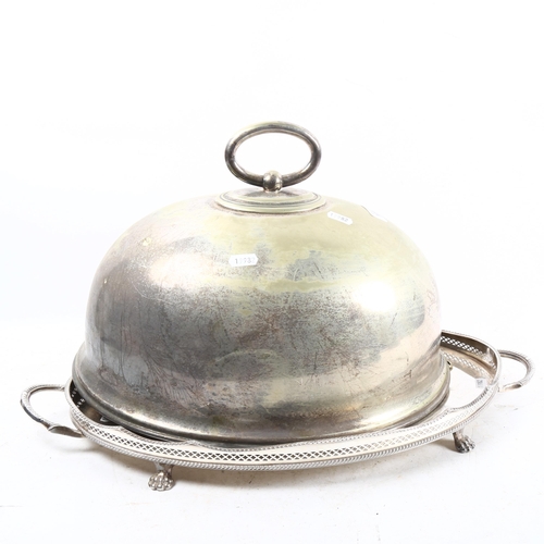 1029 - A silver plate on copper galleried tea tray on cast paw feet, and a plated meat cover