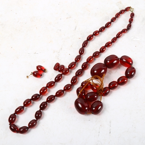 1060 - 2 red Bakelite bead necklaces and a pair of matching earrings