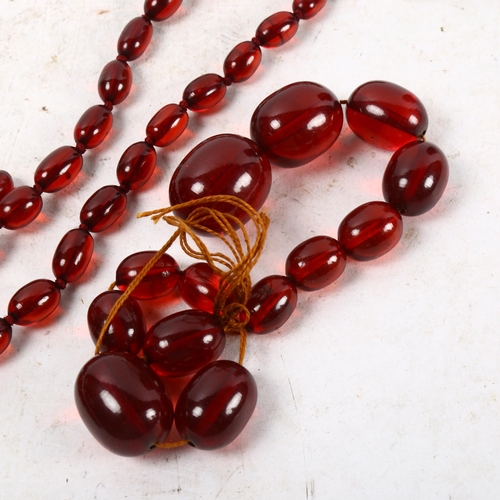 1060 - 2 red Bakelite bead necklaces and a pair of matching earrings