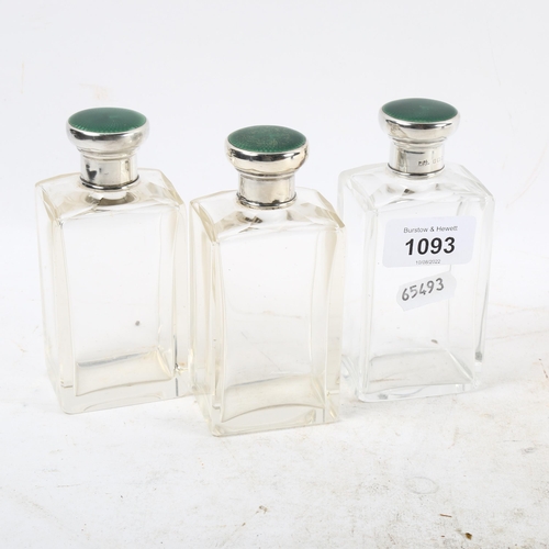 1093 - A set of George V toilet bottles, with silver and green enamel mounts, London 1931