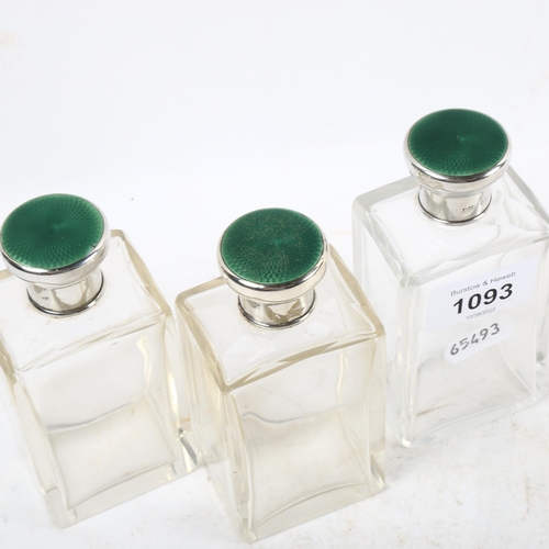 1093 - A set of George V toilet bottles, with silver and green enamel mounts, London 1931