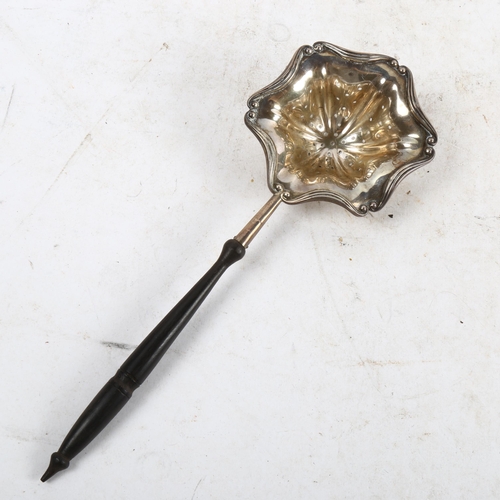 1094 - An early 20th century American tea strainer, with pierced silver bowl and turned wood handle, by the... 