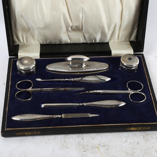 1098 - An early 20th century 8-piece engine turned silver manicure set, in fitted case