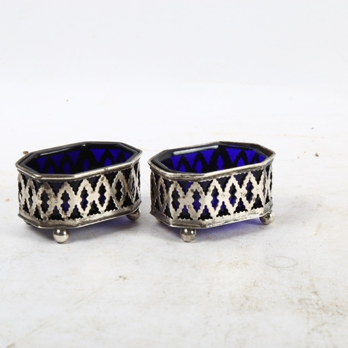 1099 - A pair of miniature pierced silver salts, with Bristol blue glass liners