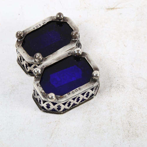 1099 - A pair of miniature pierced silver salts, with Bristol blue glass liners