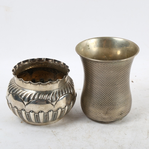 1101 - An embossed silver bowl, and an engine turned silver beaker (2)