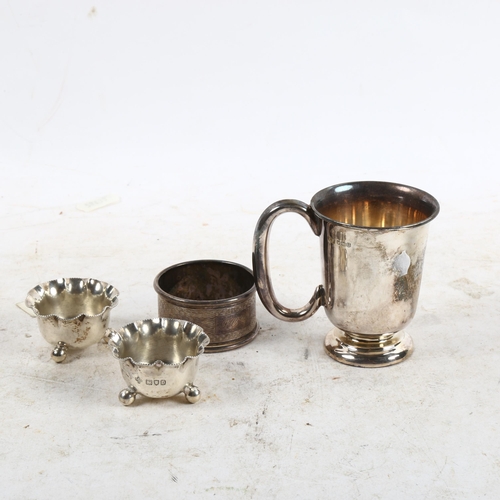 1111 - A pair of miniature silver salts, a silver napkin ring, and a small silver tankard