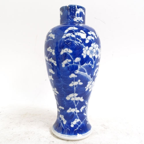 217 - A pair of Chinese blue and white Prunus pattern baluster jars and covers, height 33cm