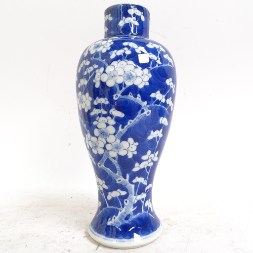 217 - A pair of Chinese blue and white Prunus pattern baluster jars and covers, height 33cm