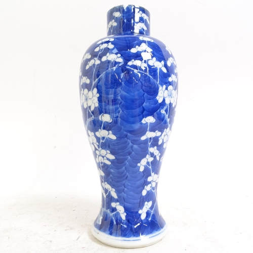 217 - A pair of Chinese blue and white Prunus pattern baluster jars and covers, height 33cm