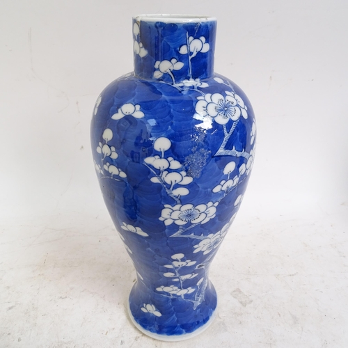 217 - A pair of Chinese blue and white Prunus pattern baluster jars and covers, height 33cm