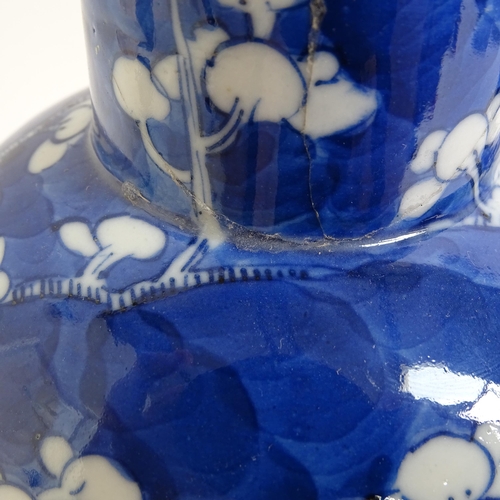 217 - A pair of Chinese blue and white Prunus pattern baluster jars and covers, height 33cm