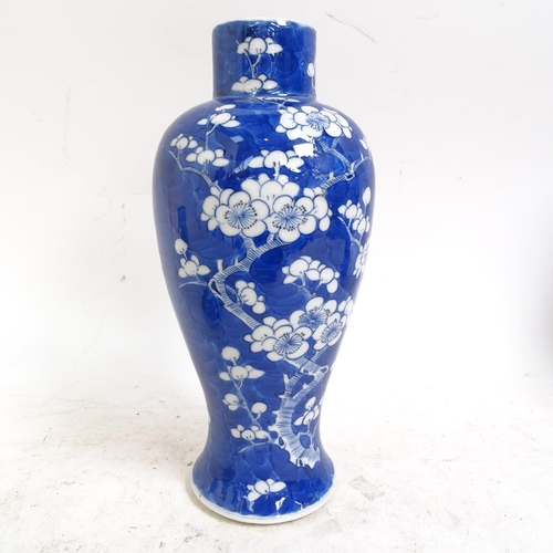 217 - A pair of Chinese blue and white Prunus pattern baluster jars and covers, height 33cm