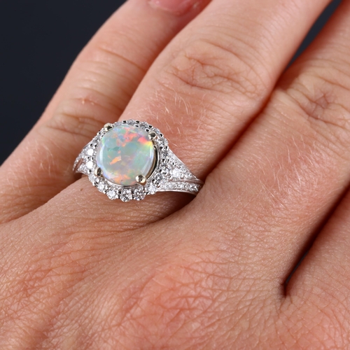 113 - An 18ct white gold lightning ridge opal and diamond cluster ring, set with circular cabochon opal an... 