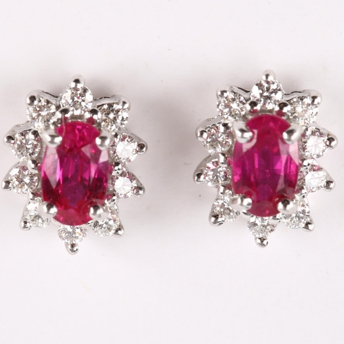 147 - A pair of 18ct gold ruby and diamond cluster earrings, set with oval mixed-cut ruby and modern round... 