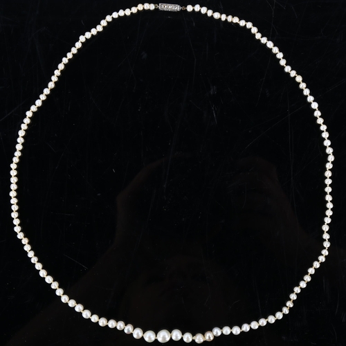 149 - A natural pearl necklace, the 129 graduated pearls measuring 6.6mm - 7.2mm to 3.3mm, to a rose-cut d... 