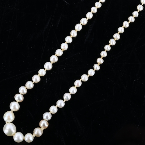 149 - A natural pearl necklace, the 129 graduated pearls measuring 6.6mm - 7.2mm to 3.3mm, to a rose-cut d... 