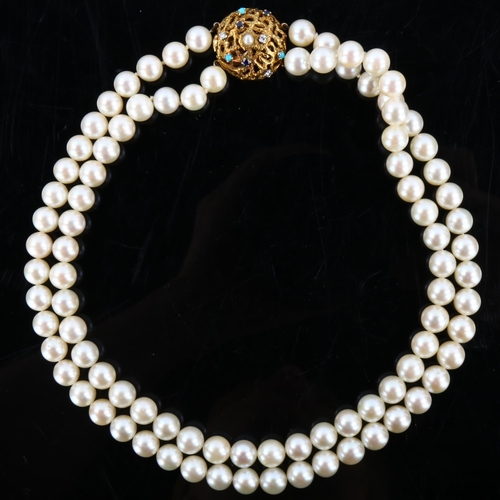 152 - A mid-20th century double-strand cultured pearl necklace, with 18ct gold gem set textured clasp, mak... 