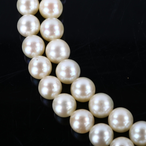 152 - A mid-20th century double-strand cultured pearl necklace, with 18ct gold gem set textured clasp, mak... 