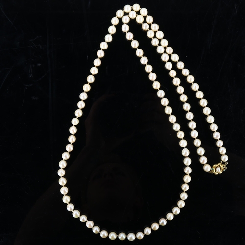 153 - A long single-strand cultured pearl necklace, with unmarked gold pearl and emerald textured clasp, n... 