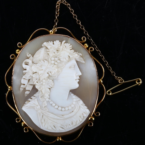 156 - A 19th century shell cameo brooch, depicting Dionysus, Greek God of Fertility, in 9ct gold scrollwor... 