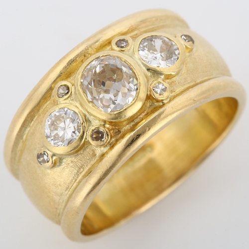 158 - An 18ct gold diamond band ring, in the style of Elizabeth Gage, set with old, modern round brilliant... 