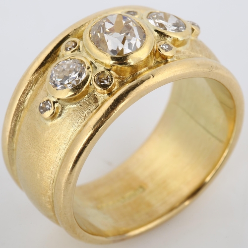 158 - An 18ct gold diamond band ring, in the style of Elizabeth Gage, set with old, modern round brilliant... 