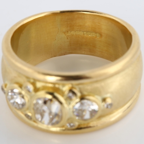 158 - An 18ct gold diamond band ring, in the style of Elizabeth Gage, set with old, modern round brilliant... 