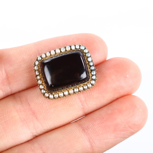 162 - A Victorian garnet and pearl cluster memorial brooch, unmarked gold settings with rectangular caboch... 