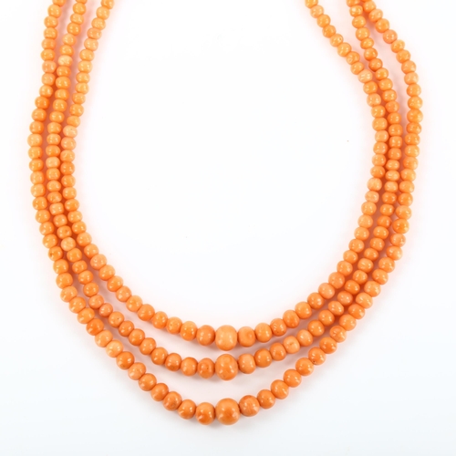 168 - A triple-strand graduated coral bead necklace, with gilt-metal clasp, beads ranging from 2.6mm to 6.... 