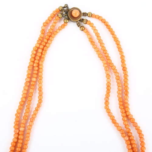 168 - A triple-strand graduated coral bead necklace, with gilt-metal clasp, beads ranging from 2.6mm to 6.... 