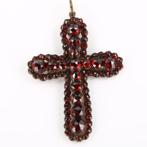 181 - A Victorian Bohemian faceted garnet cross pendant, unmarked yellow metal settings, pendant height ex... 